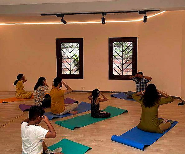 Yoga practice in the AANGAN hall at Namma Ashram